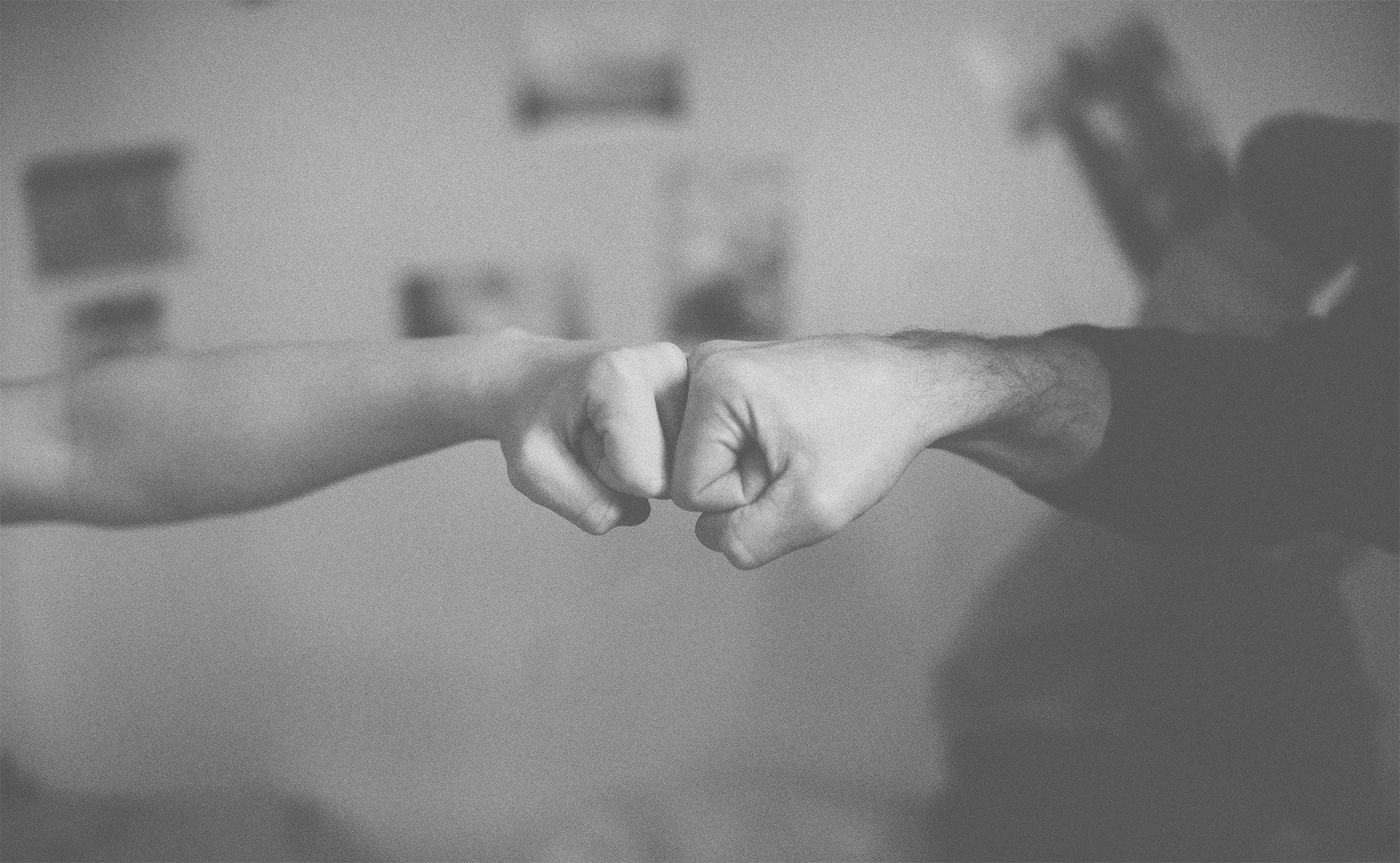 Close up of two people fistbumping
